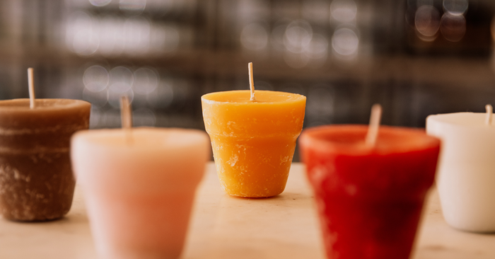 a bundle of fall votives in a hollowed out log