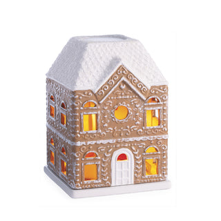 A gingerbread house-shaped decorative light with a white textured roof, white trim, and warm yellow-orange glowing windows on a plain white background.